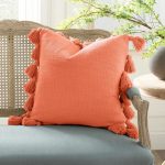 Square Cream Woven Cotton Slub Throw Pillow with Decorative Corner Tassels.
