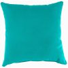 Vibrant aqua decorative pillows styled on a modern patio furniture set by the pool.