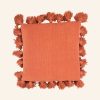 Close-up of the breathable cotton slub weave and artisanal tassel detail.