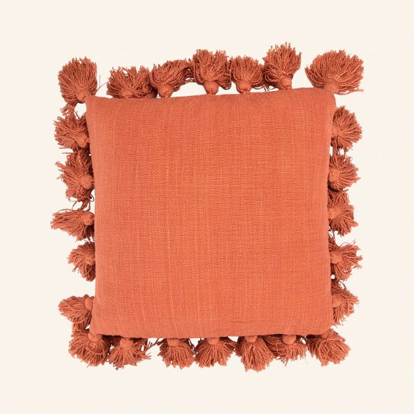 Close-up of the breathable cotton slub weave and artisanal tassel detail.